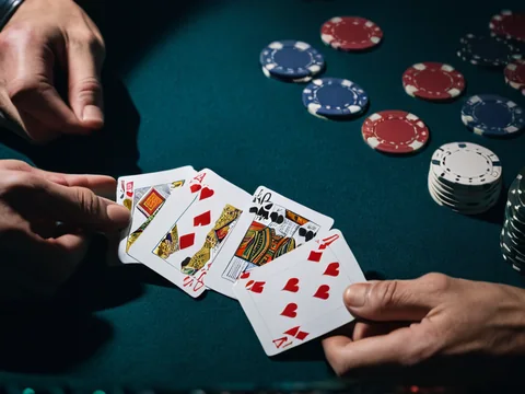 32 Cards on the AllPanel deck &mdash; four small card hands spread on blue baize